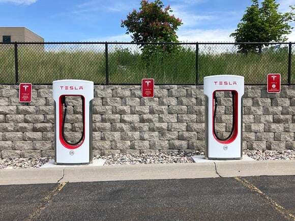 Two white and red tesla charging stations