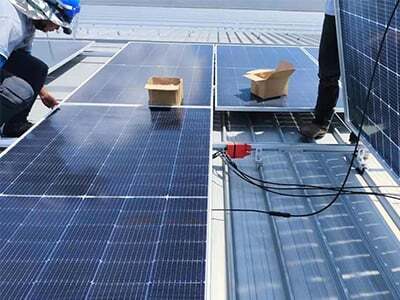 Workers installing PV system on the roof
